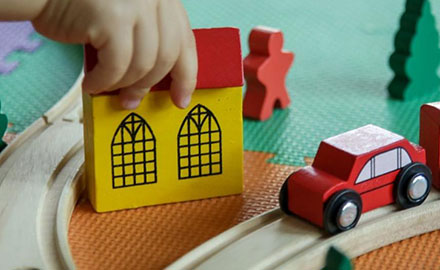 Child playing with wooden toys