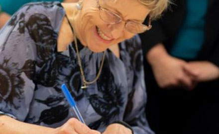 Julie Price signing paper