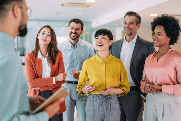 Shot of a businessman delivering a speech during a meeting in conference room. Businessman leading a training class for professionals. Businessman talking on seminar in front of his colleagues. Group of business persons in business meeting. Group of entrepreneurs on meeting in board room. Creative business team on meeting in the office.