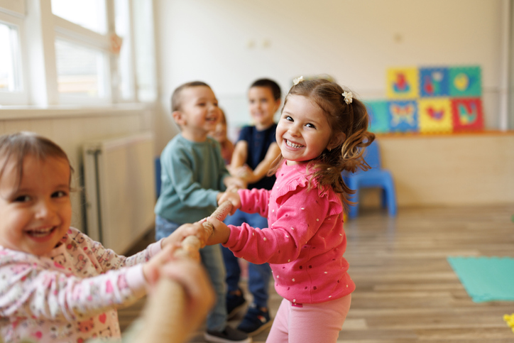 Smiling young children playing in classroom