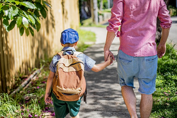 Father and child walking to school