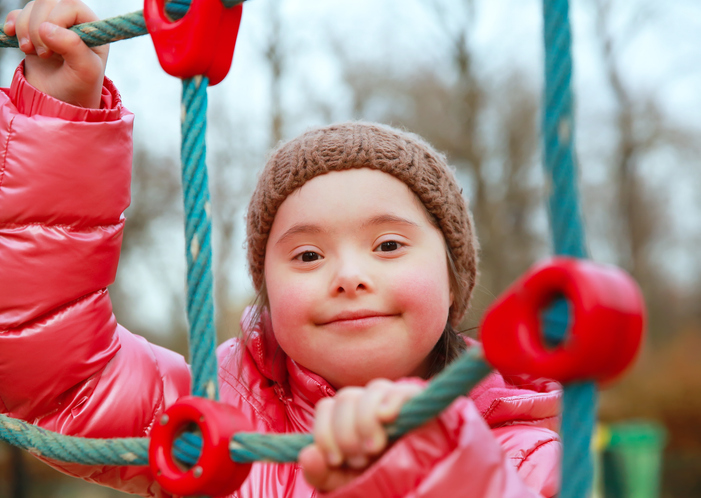 Child climbing on a rope climb